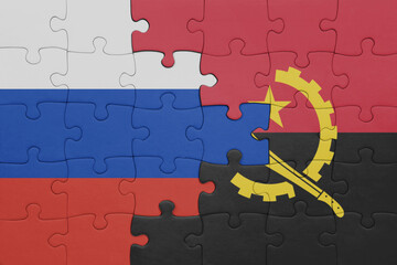 puzzle with the colourful national flag of angola and flag of russia.