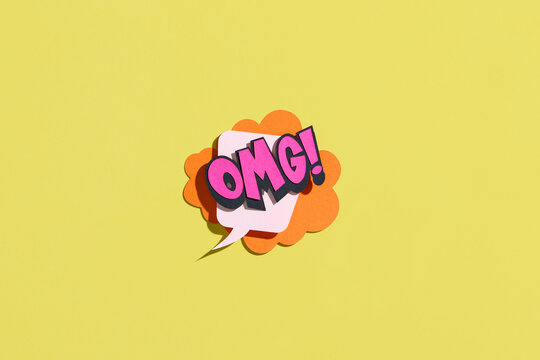 Speech bubble sticker with OMG. Paper cut work.