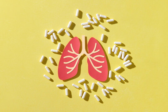 Human lungs surrounded by pills.