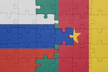 puzzle with the colourful national flag of cameroon and flag of russia.