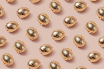 Festive eggs decorated with golden foil laying in horizontal rows