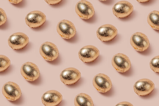 Festive eggs decorated with golden foil laying in horizontal rows