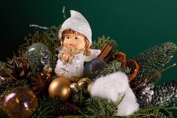 Small Doll Sitting on Top of a Christmas Tree