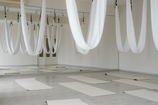 Interior view of spacious wellness center with hammocks and mats