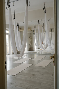 Interior view of spacious wellness center with hammocks and mats