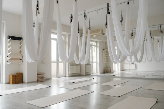 Interior view of spacious wellness center with hammocks and mats