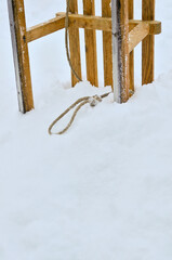 Wooden sled stuck in a snowbank