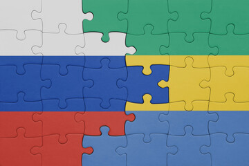 Fototapeta premium puzzle with the colourful national flag of gabon and flag of russia.