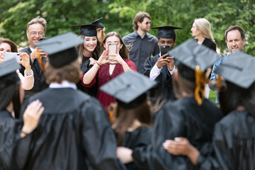 Grad: Group Of Graduate Friends Pose For Parents