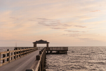 Fototapeta premium Pier at Fairhope, AL stretching into the ocean during sunset