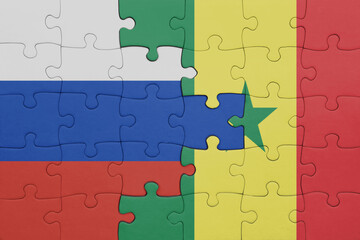 puzzle with the colourful national flag of senegal and flag of russia.