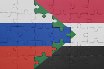 puzzle with the colourful national flag of sudan and flag of russia.