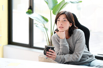 Thoughtful Professional  with Coffee in business office