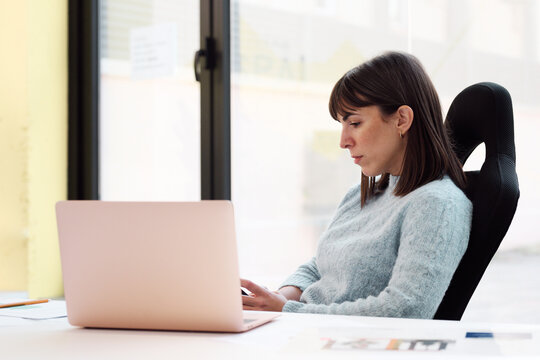 Diligent Professional consulting her smartphone 