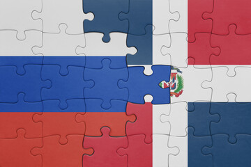 puzzle with the colourful national flag of dominican republic and flag of russia.