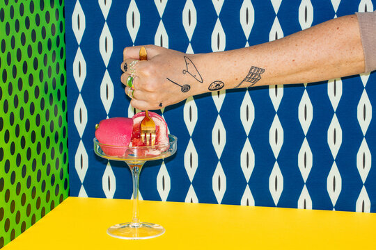 The pastry chef tries an artful dessert in a colorful setting