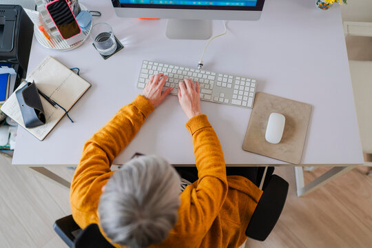 Overhead View of Woman Typing on Keyboard