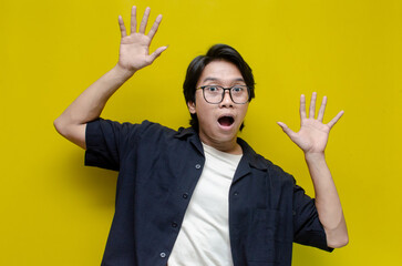 young asian man surprised with wow expression celebrating something. overjoyed  young asian man...