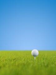 A golf ball on a golf tee on a lawn. Selective focus - very shallow depth of field. Blue background.