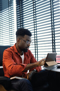 Focused Man Working on Tablet in Office