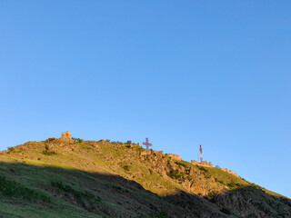 Fototapeta premium Light and Shadow Dance Against an Afternoon Blue Sky. Orthodox cross symbol for Christianity. Somewhere In Macedonia 2024.