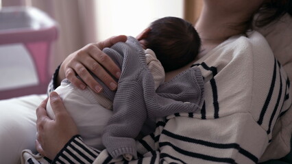 Fototapeta premium Affectionate Maternal Scene - Exhausted Mother in Bed, Holding Newborn on Chest in First Week of Life
