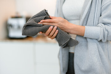 A woman wipes her hands with a towel