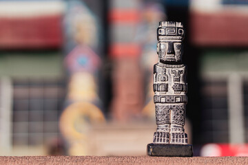 Miniature of monolith from the Tiahuanaco culture. Isolated with space for text. With colorful...