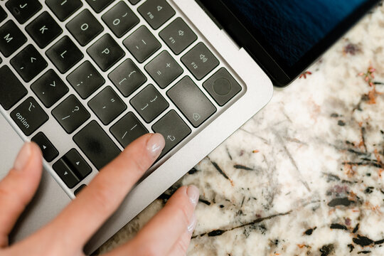 A woman uses a laptop indoors