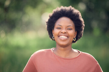 Face, smile and black woman in park, outdoor and afro for hair, relax and bokeh for vacation. Happiness, spring and African person with joy, portrait and travel in garden and weekend for nature