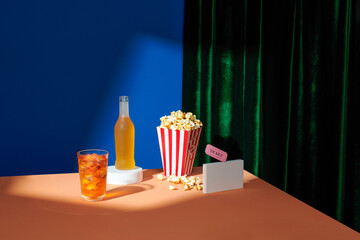 Watch a movie with popcorn and movie tickets and soft drinks.