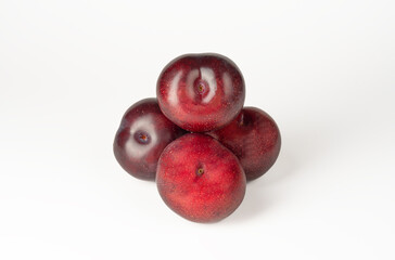 Red plums isolated on white background