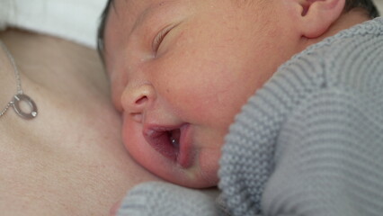 Infant's First Days - Sleeping Peacefully on Mother's Chest During Early Life, newborn baby close-up face with cute expression