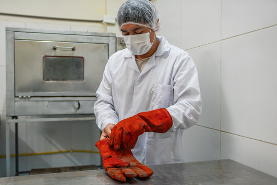 Factory Worker Putting on Gloves