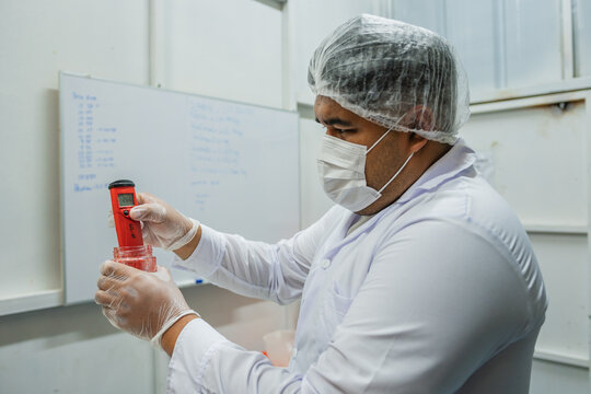 Plus size Scientist Measuring Ph at Laboratory