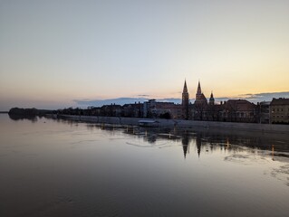 View of Szeged at dusk, seen over an overflown Tisza river