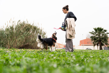 Woman with dog enjoying a leisurely walk in the park