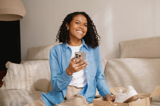 Smiling Woman Browsing on Smartphone