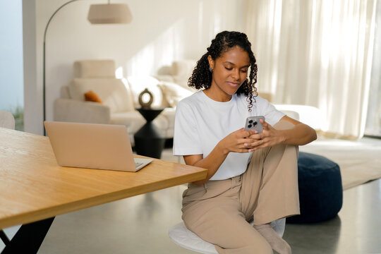 Professional Woman with phone Multi-Tasking at Home