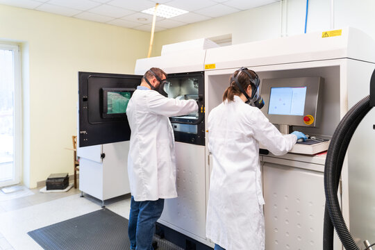 People Using 3D Printer in Laboratory Room