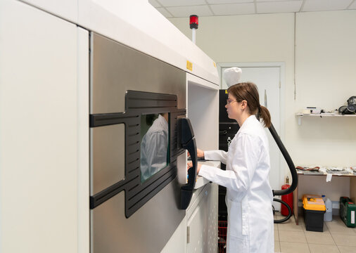 Woman Using 3D Printer in Laboratory Room