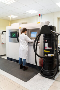 Woman Using 3D Printer in Laboratory Room
