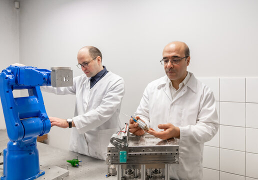 Researchers Working At Robotics Laboratory Room