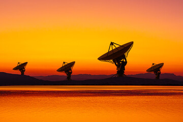 Sunset silhouettes of telecommunication antennas