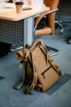 The briefcase is near the desk