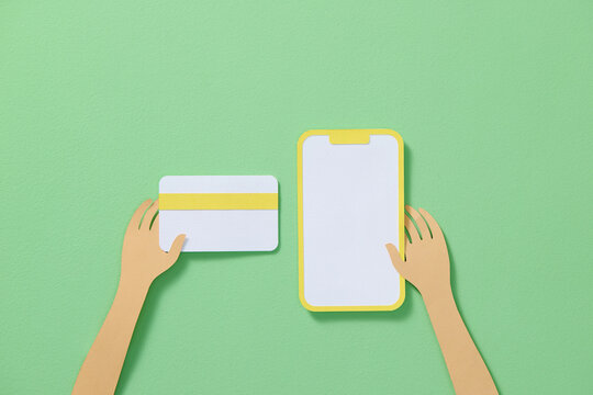 Hands hold smartphone and debit or credit card and make e-payment. 