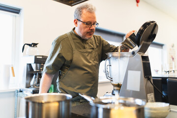Man using cooking equipment in commercial kitchen