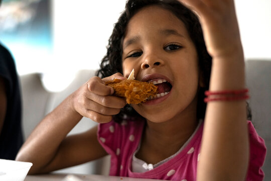 Toddler eating fired chicken
