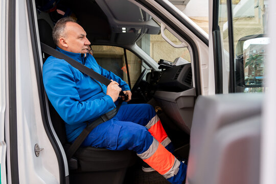 Paramedic buckling his seat belt in an ambulance
