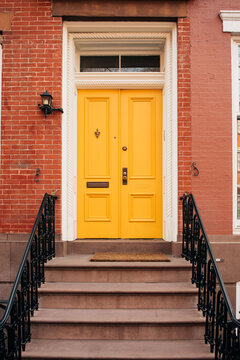 Vibrant Yellow Door on Red Brick Building